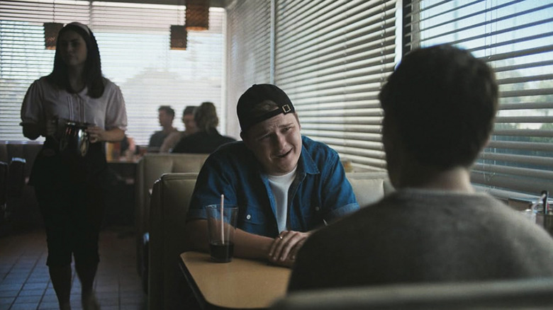 Ian mocking Bear as he sits across from him in a diner booth in Obsession