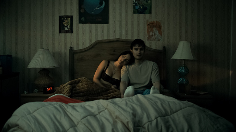 Nikki leans her head on Bear's shoulder in bed in Obsession