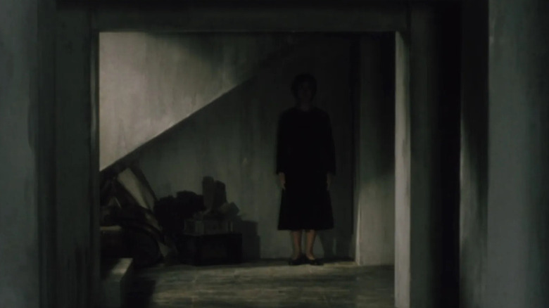 A ghost woman lurks in the darkness in Pulse
