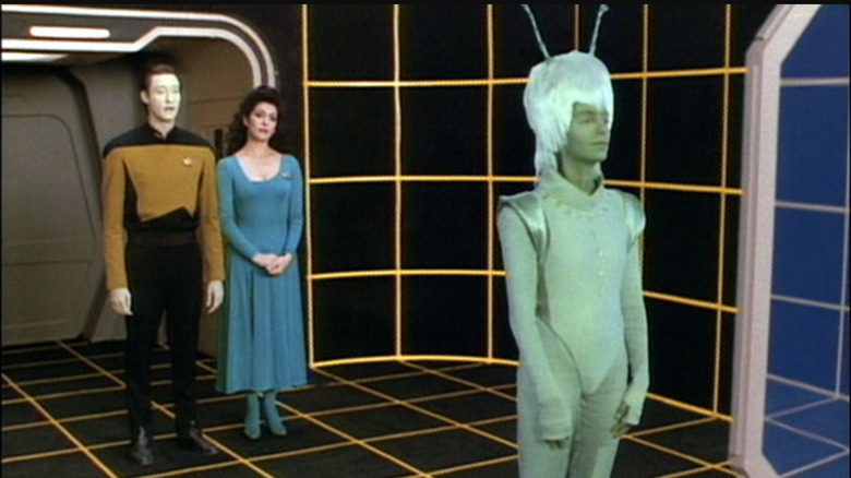 Data and Troi look at Andorian hologram