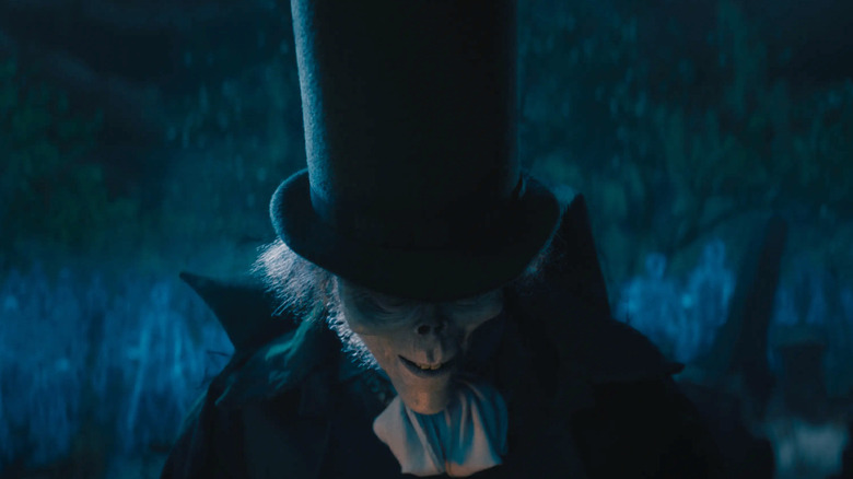 Jared Leto as Hatbox Ghost in a graveyard in Haunted Mansion (2023)