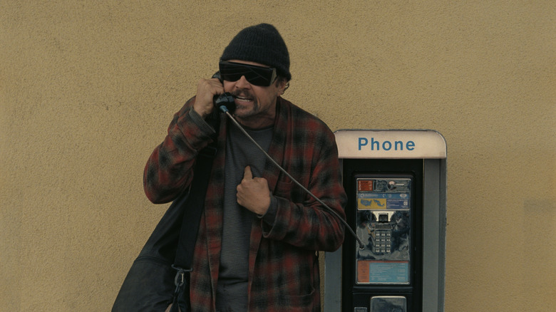 Bob Ferguson talking angrily on a payphone in One Battle After Another