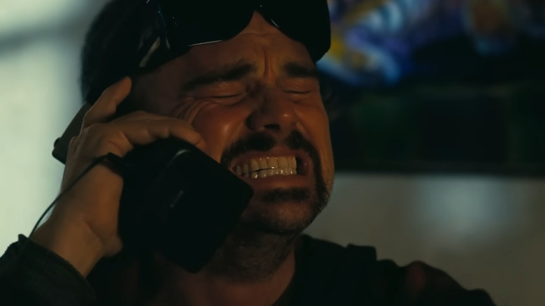 Bob Ferguson looking frustrated on the phone in One Battle After Another