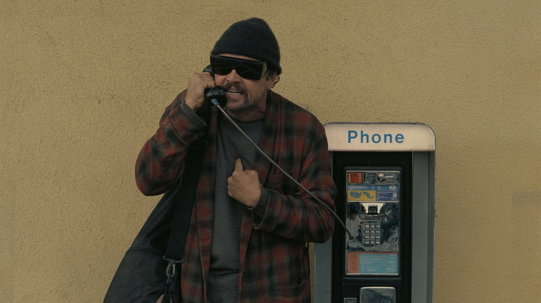 Bob on a payphone in One Battle After Another