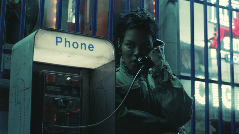 Perfidia Beverly Hills on a payphone at night in One Battle After Another