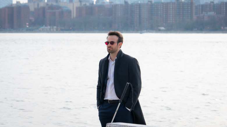 Charlie Cox as Matt Murdock standing by the river in Daredevil: Born Again