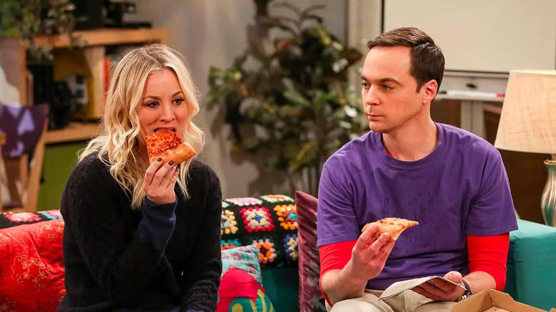 Penny eating pizza and Sheldon watching on The Big Bang Theory