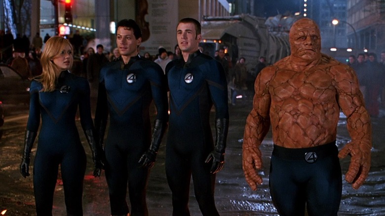 The Invisible Woman (Jessica Alba), Mr. Fantastic (Ioan Gruffudd), The Human Torch (Chris Evans), and The Thing (Michael Chiklis) stand together in Fantastic Four (2005)