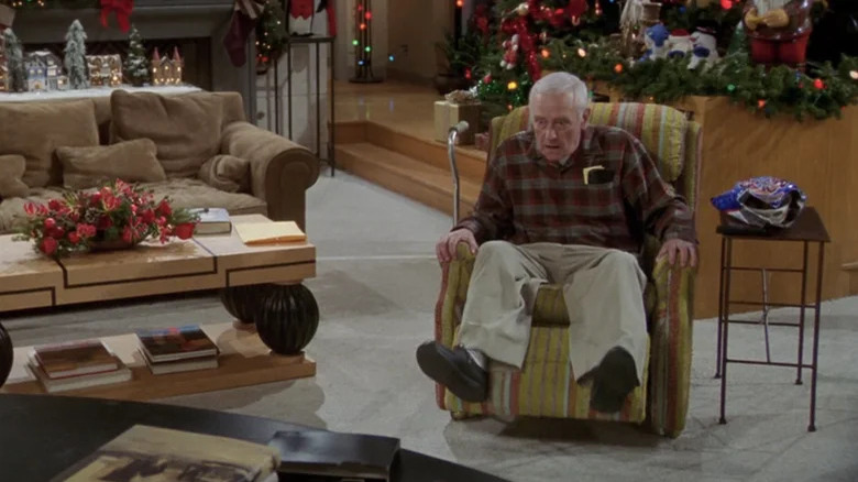 Martin sits in his recliner stunned by what he sees on TV in Frasier