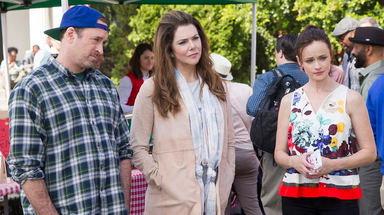 Luke Lorelai and Rory in the town square looking confused in Gilmore Girls: A Year in the Life