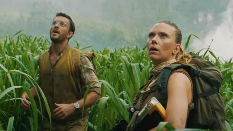 Scarlett Johansson as Zora Bennett and Jonathan Bailey as Dr. Henry Loomis gaze in awe at dionsaurs in Jurassic World Rebirth