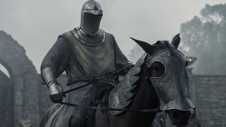 Peter Claffey as Ser Duncan the Tall armored in mail and a helmet while riding his horse in A Knight of the Seven Kingdoms