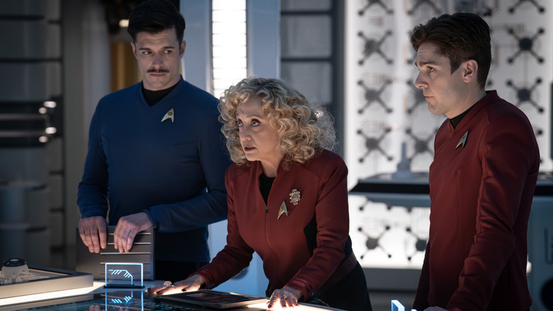 Dan Jeannotte as Sam Kirk, Carol Kane as Pelia and Martin Quinn as Scotty in the engineering bay in season 3 of Star Trek: Strange New Worlds