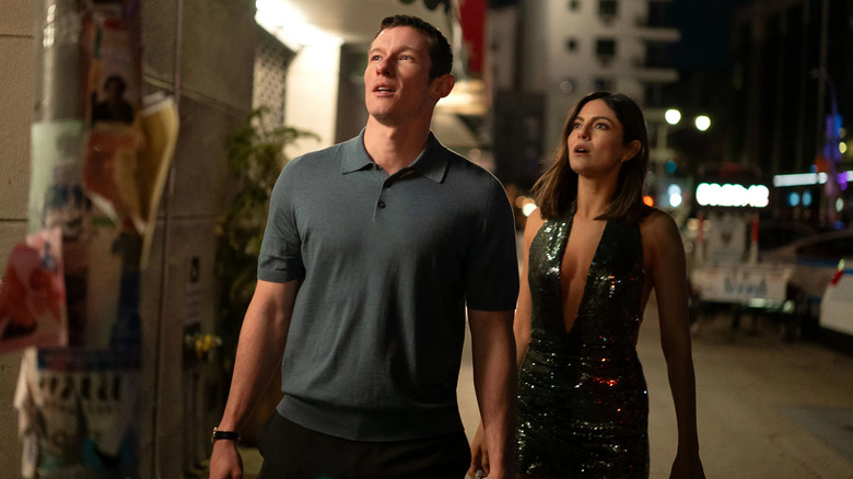 Owen and Allie stand on a sidewalk in New York City and look up at something off camera in One Night Only
