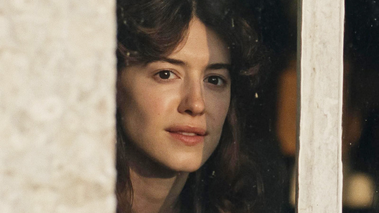 Elinor looking at something out a window in Sense and Sensibility