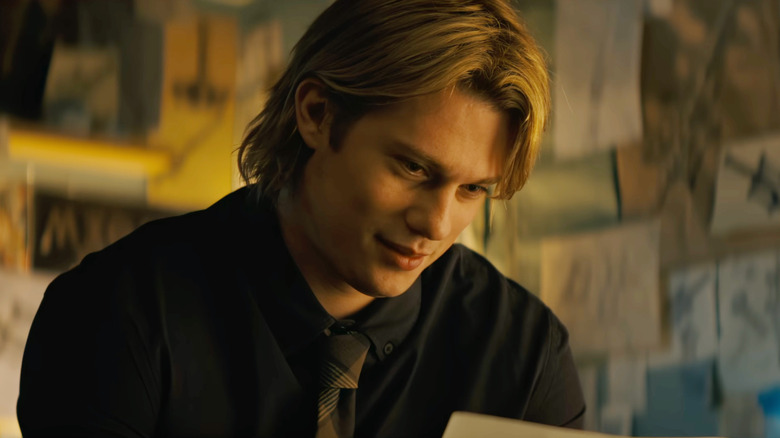 Nicholas Galitzine as Adam looking at a paper in a room covered in drawings in Masters of the Universe (2026)