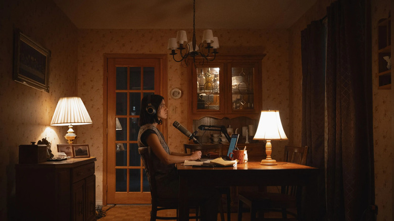 Evy sitting at the table recording her podcast in undertone