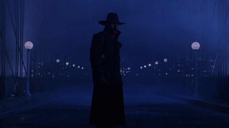 The Shadow standing on a dark street in The Shadow
