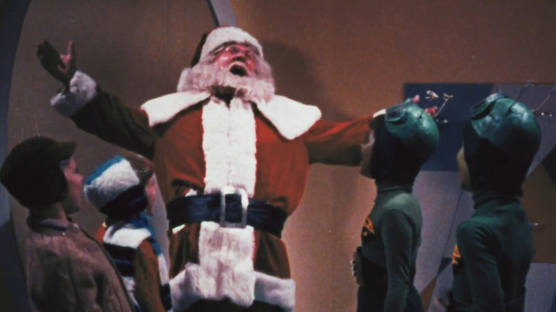 Santa Claus laughing with Earth and Martian children in Santa Claus Conquers the Martians