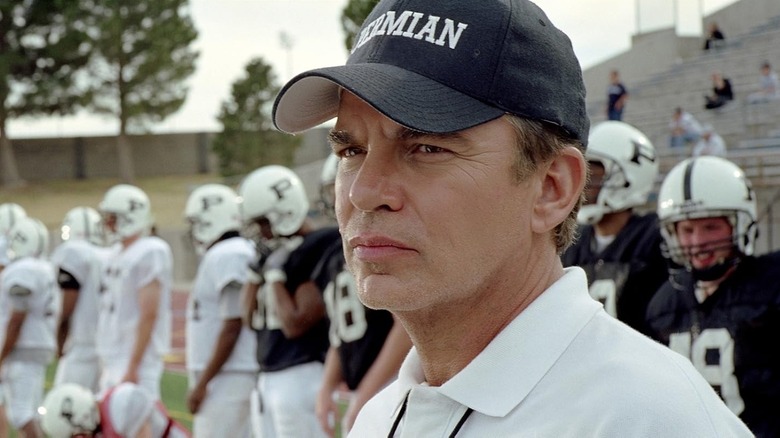 Billy Bob Thornton as Gary Gaines wearing a baseball cap in Friday Night Lights