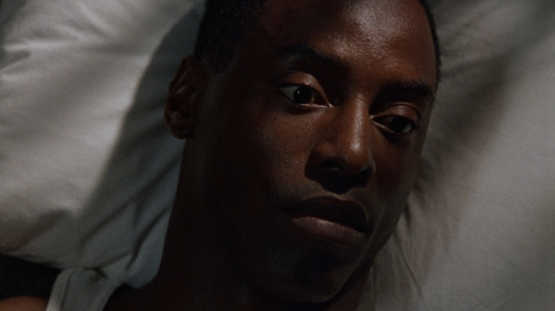 Isaiah Washington as Frank Louis Beechum lying on a pillow in True Crime