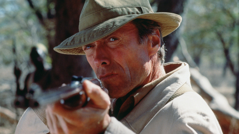 Clint Eastwood holds an elephant rifle in the role of John Wilson in the white fisher