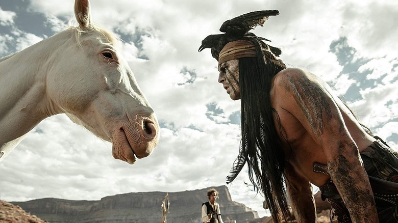 Johnny Depp as Tonto staring at a horse in The Lone Ranger (2013)