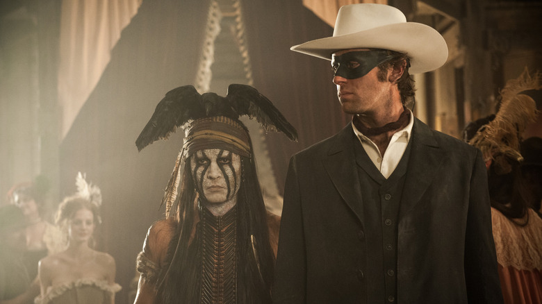 Johnny Depp as Tonto and Armie Hammer as the Lone Ranger in a saloon in The Lone Ranger (2013)