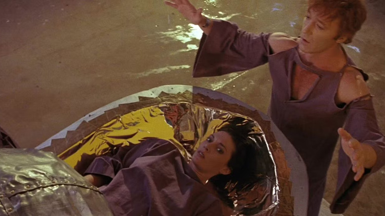 A woman in a floating coffin next to a prophet in Nightfall