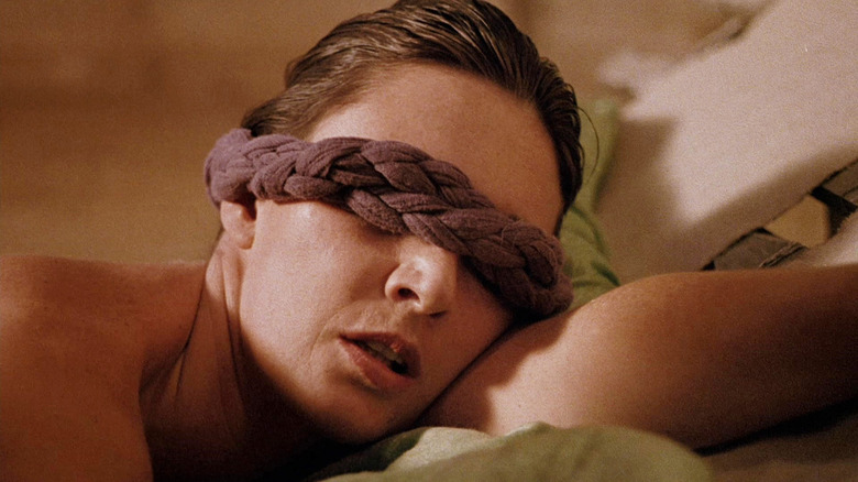 A woman with a braid tied across her eyes in Nightfall