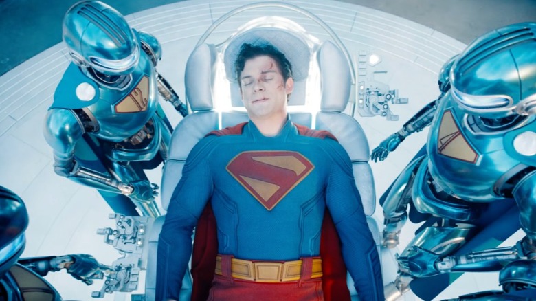 Superman sitting on a medical table with Fortress of Solitude robots looking over him in Superman (2025)