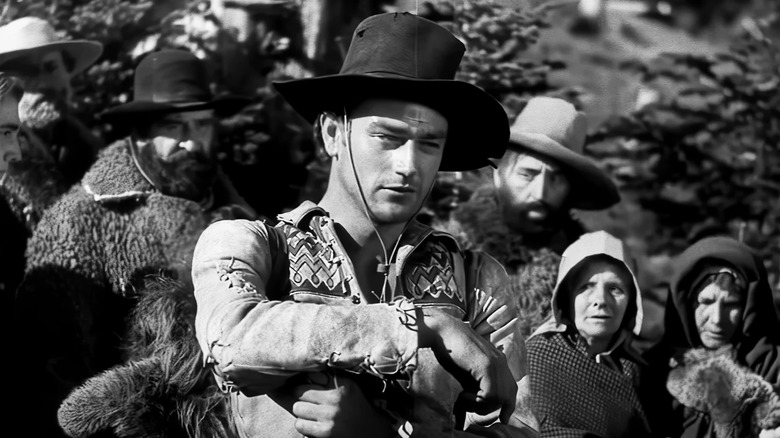 John Wayne's Breck Coleman stands in front of a crowd in The Big Trail