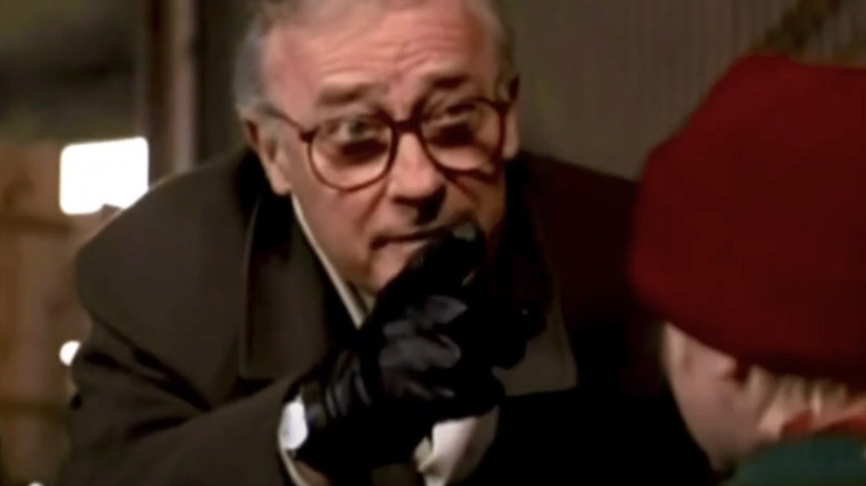 Robert Maccol from Edward Woodward bends to talk to Paul Hephart with Makoli Kalkin in the movie 
