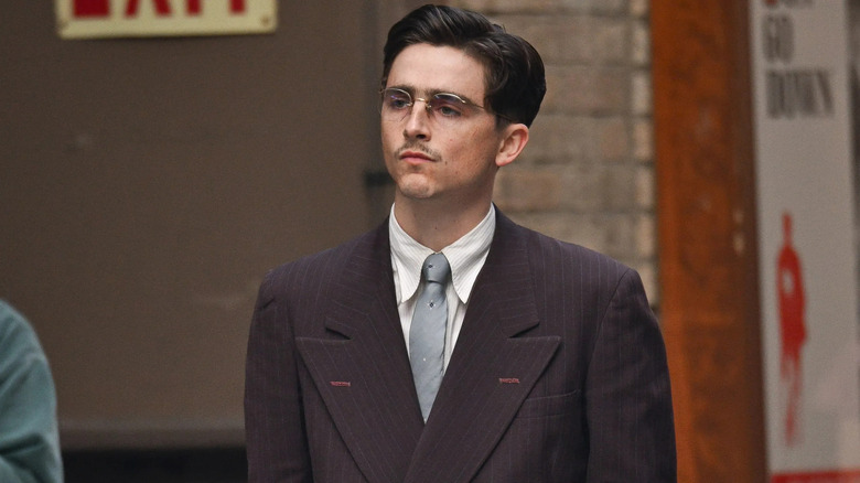 Marty Mauser in a suit in Marty Supreme