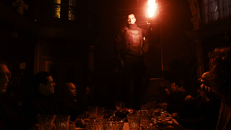 Frank Castle stands at a table with a red strait in Punisher: War area