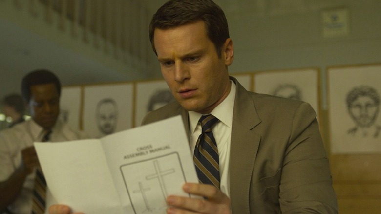 Jonathan Groff's Holden looks horrified as he reads something in Mindhunter