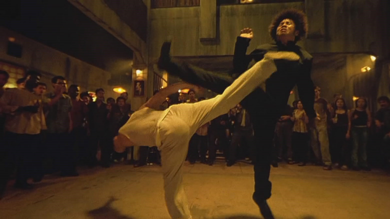 Tony Jaa applies a high kick to an opponent's jaw in "Ong Bak: Muay Thai Warrior" (2003)