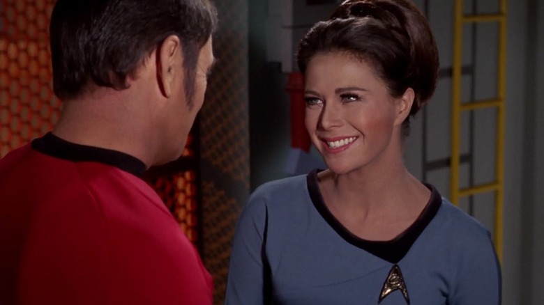Lieutenant Romaine smiling at Scotty on Star Trek