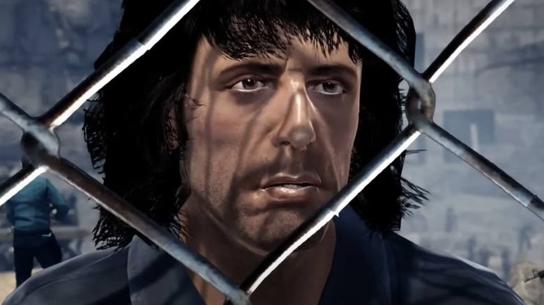 John Rambo is seen behind a chain link fence in video game form in Rambo: The Video Game