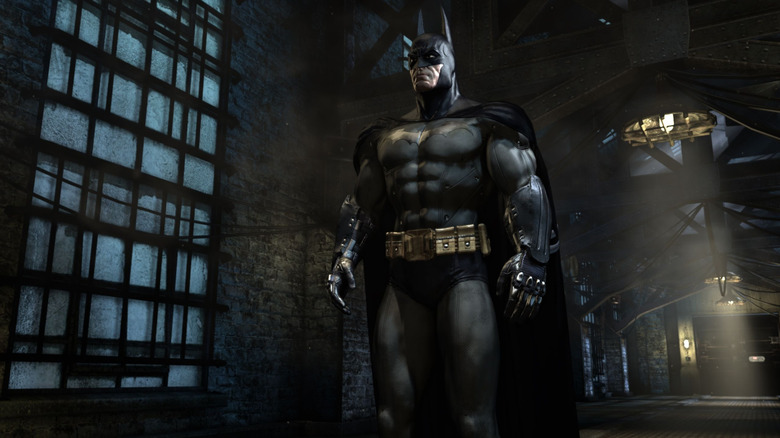 Batman standing in the halls of Arkham Asylum in Batman: Arkham Asylum