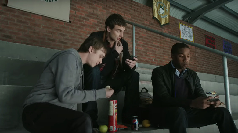 Dane DeHaan's Andrew sits cross legged and makes a gesture with his hand in Chronicle