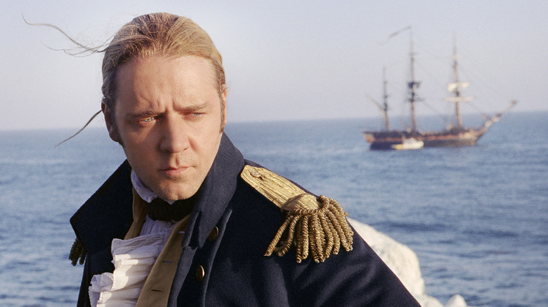 Jack Aubrey looks on as a ship sails in the background in Master and Commander: The Far Side of the World