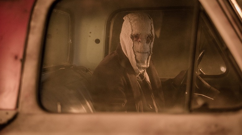 The Man in the Mask sits in a truck looking out of the window in The Strangers: Prey at Night