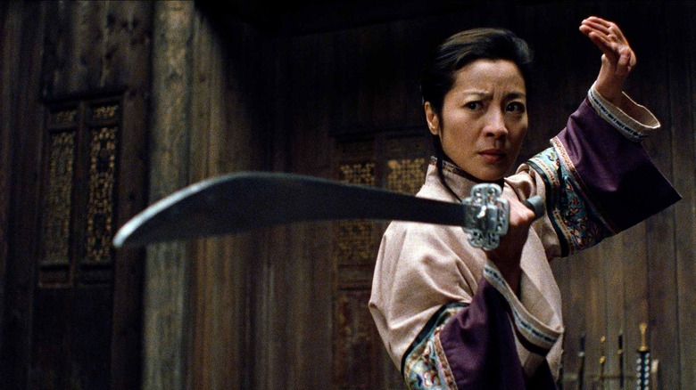Michelle Yeoh as Yu Shu Lien wielding a sword and ready to fight in Crouching Tiger, Hidden Dragon