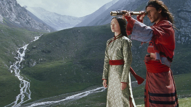 Chang Chen as Lo and Ziyi Zhang as Jen standing in a beautiful valley in Crouching Tiger, Hidden Dragon