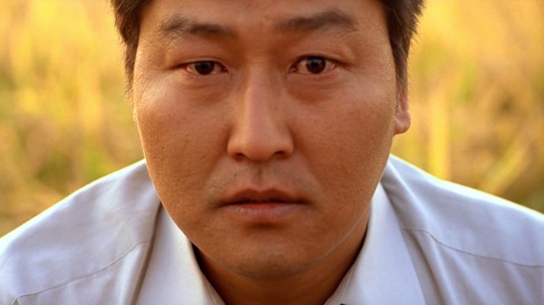 Song Kang-ho as Park Doo-man stares directly at the camera