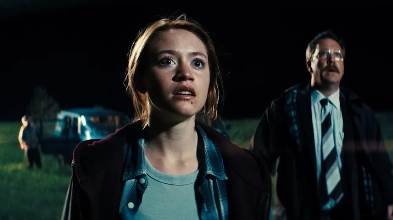 Denise and Lennart stare with wonder at an offscreen unidentified flying object