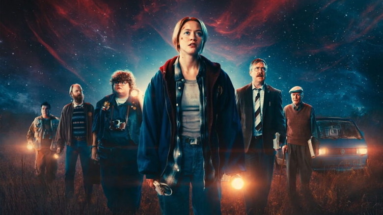 The full cast of Watch the skies assembles under the night sky
