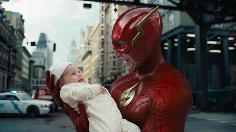 The Flash holding a baby in the street in The Flash