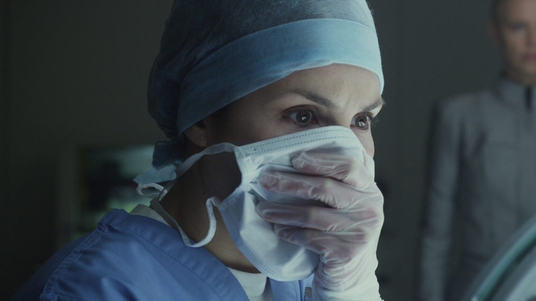 Noomi Rapace as Elizabeth Shaw staring in horror while covering her face in Prometheus